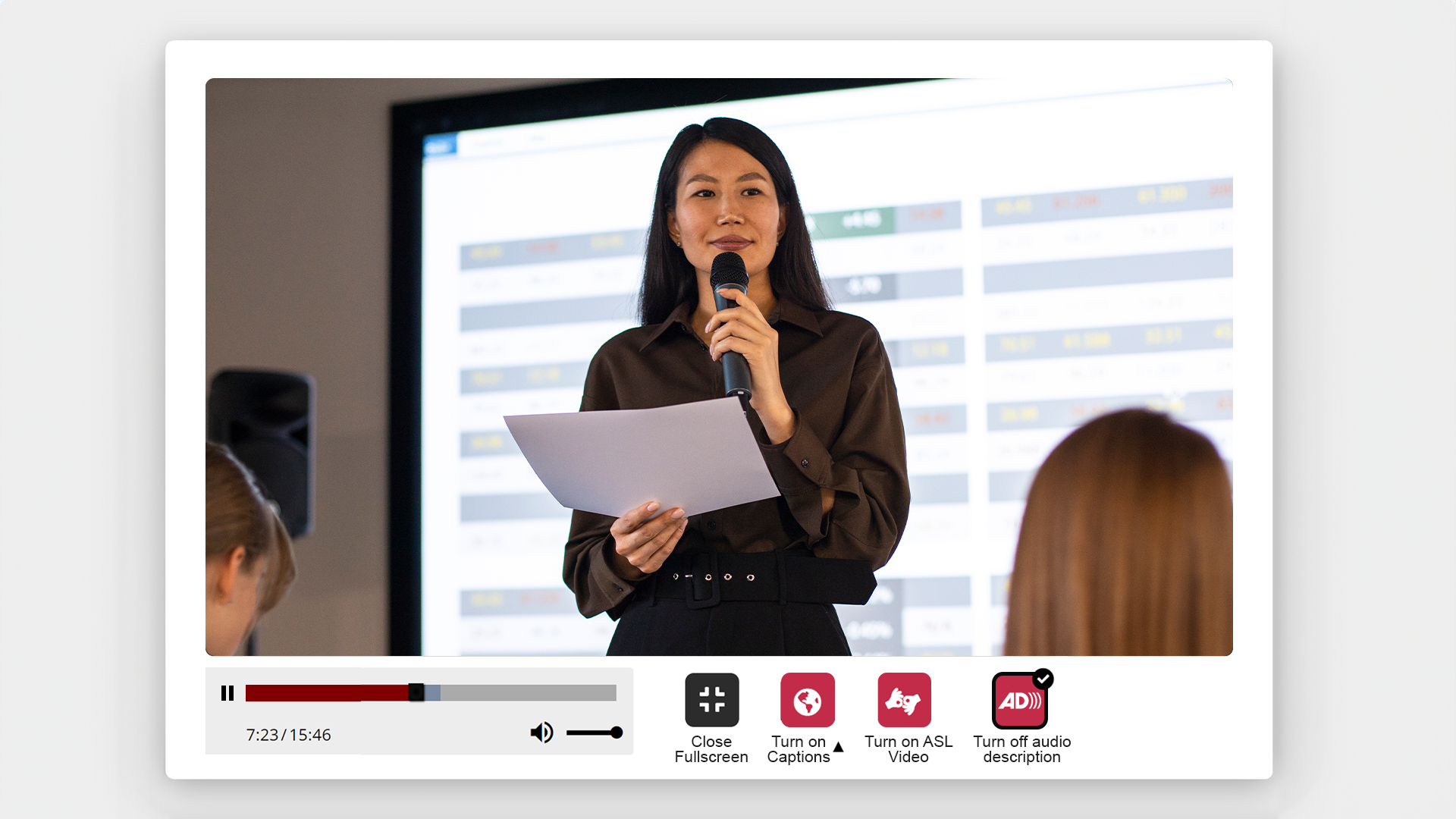 Speaker Presenting- Display of multimedia player with icons for sign language, audio description ON and captions.