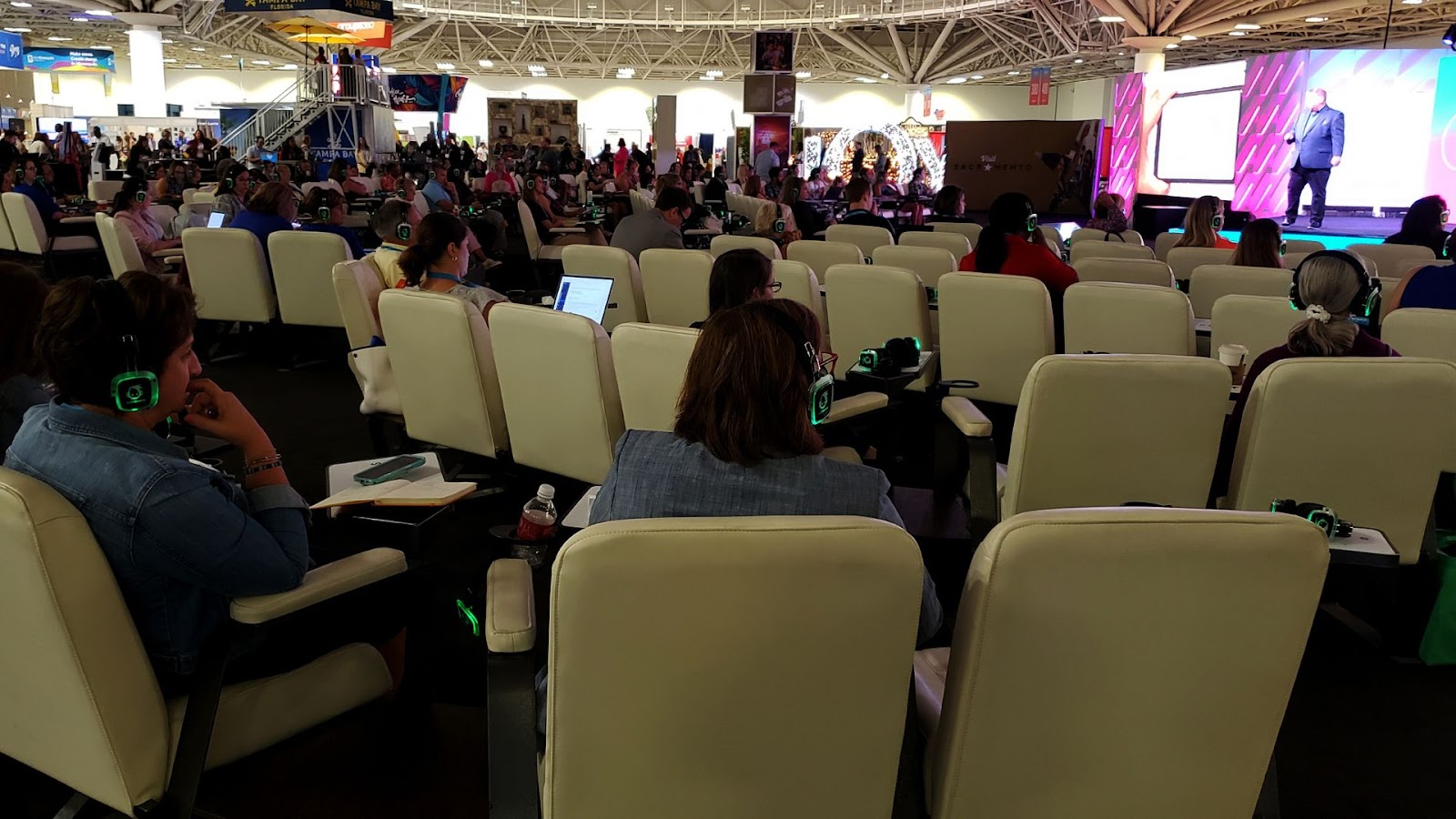 attendees with lighted headphones listening to the speaker